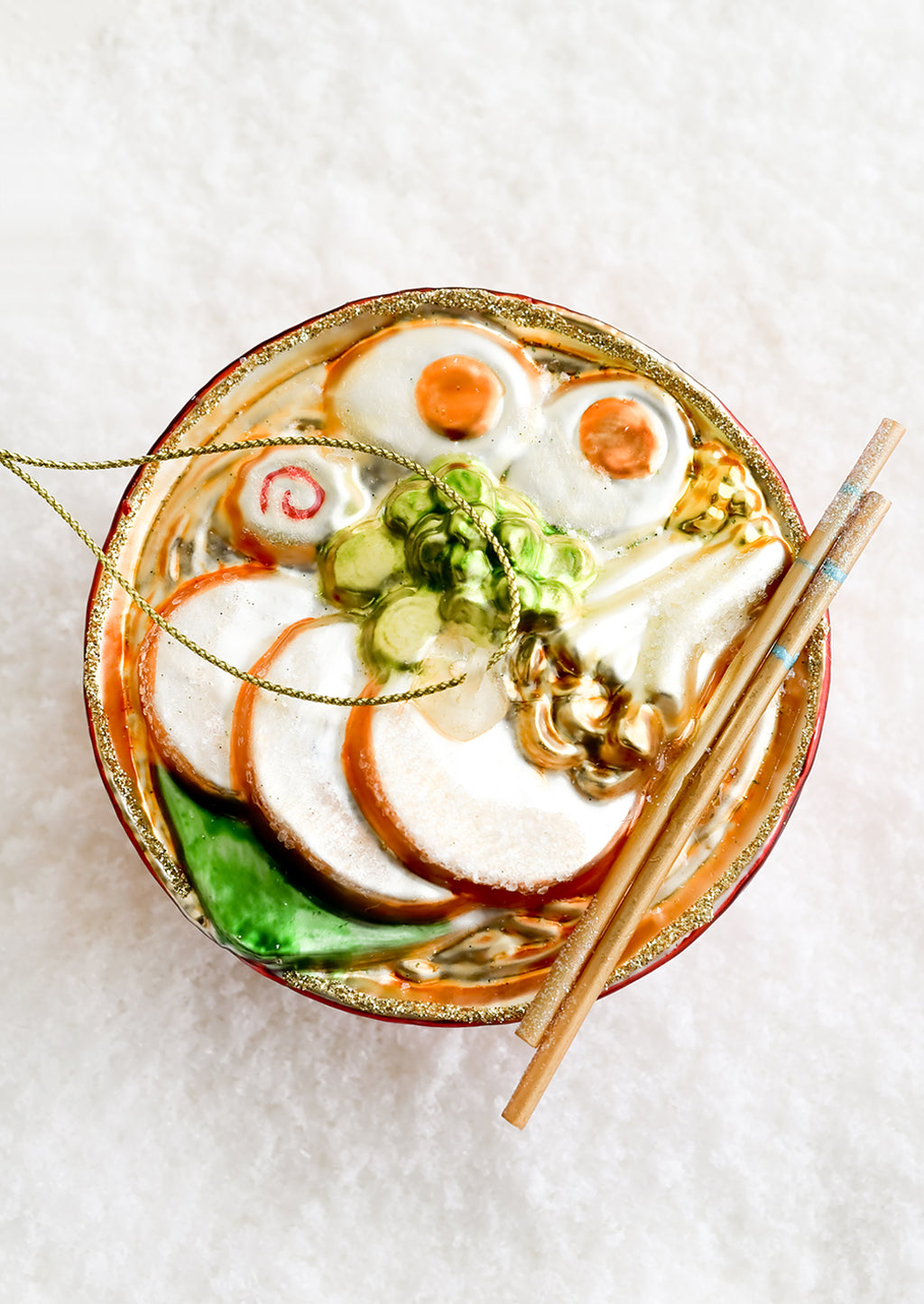 1: A decorative glass ornament in the shape of ramen noodle bowl.