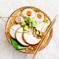 1: A decorative glass ornament in the shape of ramen noodle bowl.