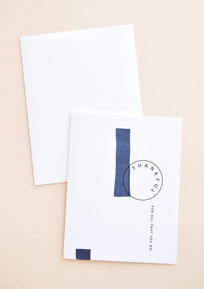 White notecard with black text "Thankful For All That You Do" and navy blue painted swatches, with white envelope.