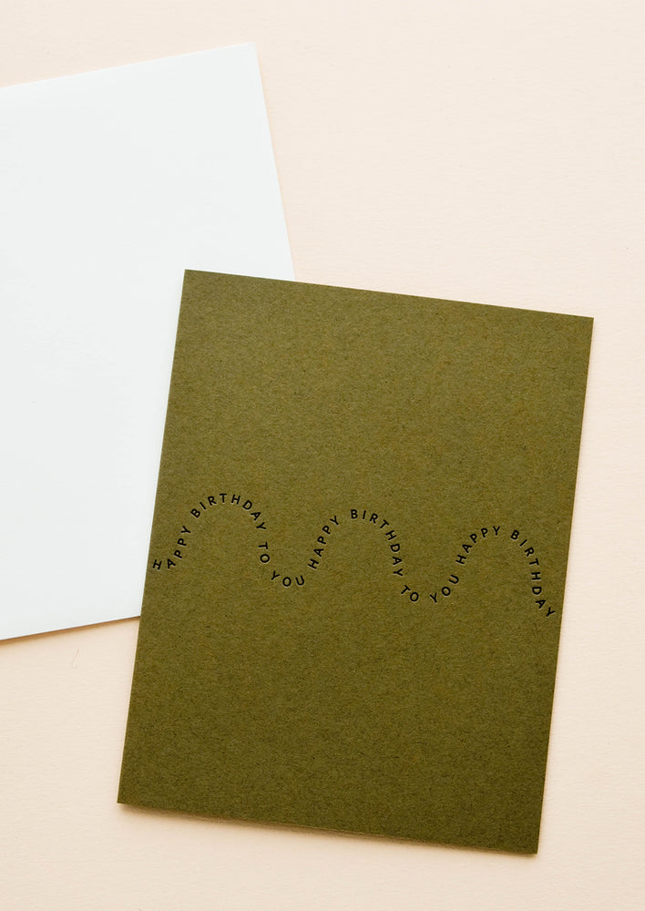 Olive green greeting card with black printed text in a wave-like formation, repeating the words "Happy birthday"