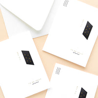 1: Three white greeting cards with minimal black and white geometric design and small gold text