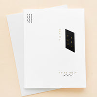 2: White greeting card with minimal black and white geometric design and small gold text