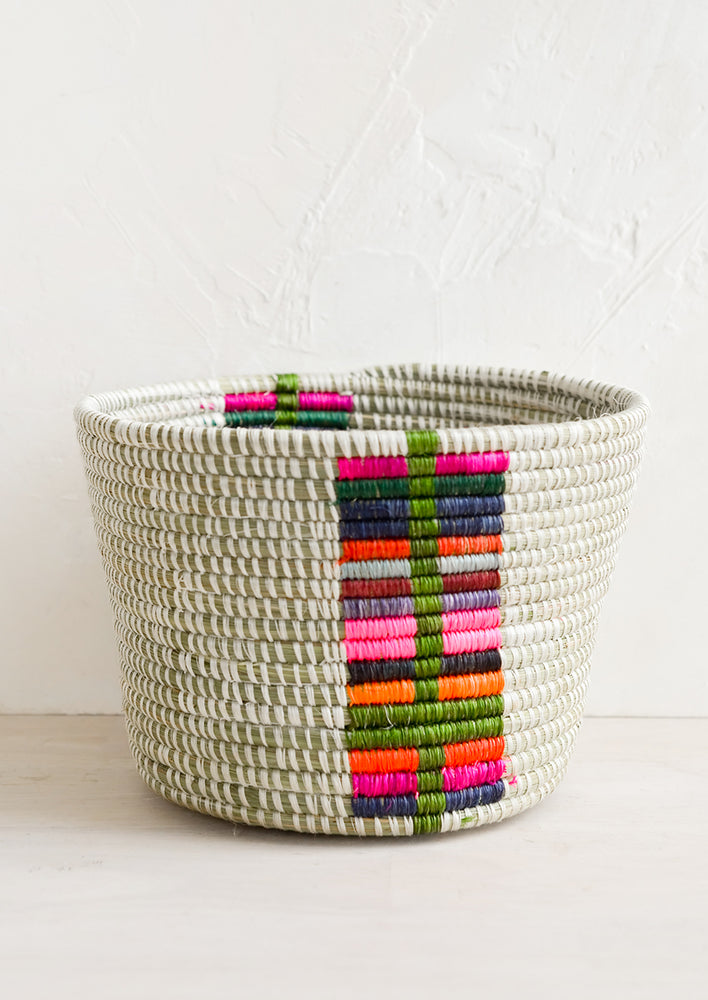 Chroma Multi: A round planter basket with colorful panel at front.