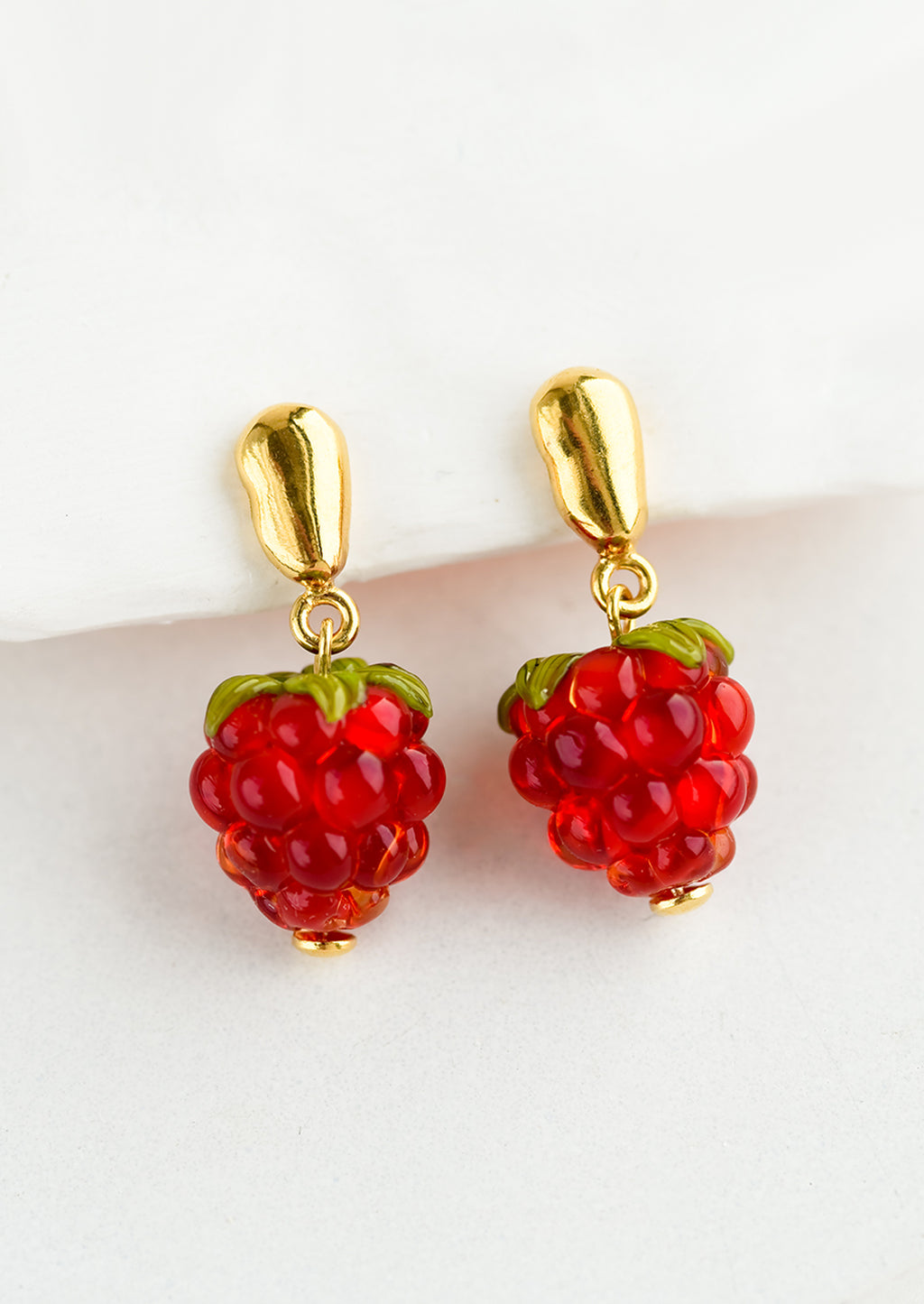 1: A pair of glass earrings in shape of raspberries.
