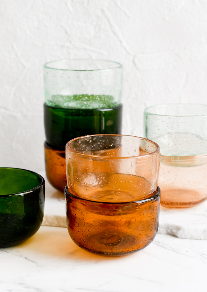 Small tinted glass bowls in assorted colors.