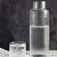 1: A tall glass decanter with small matching cup.