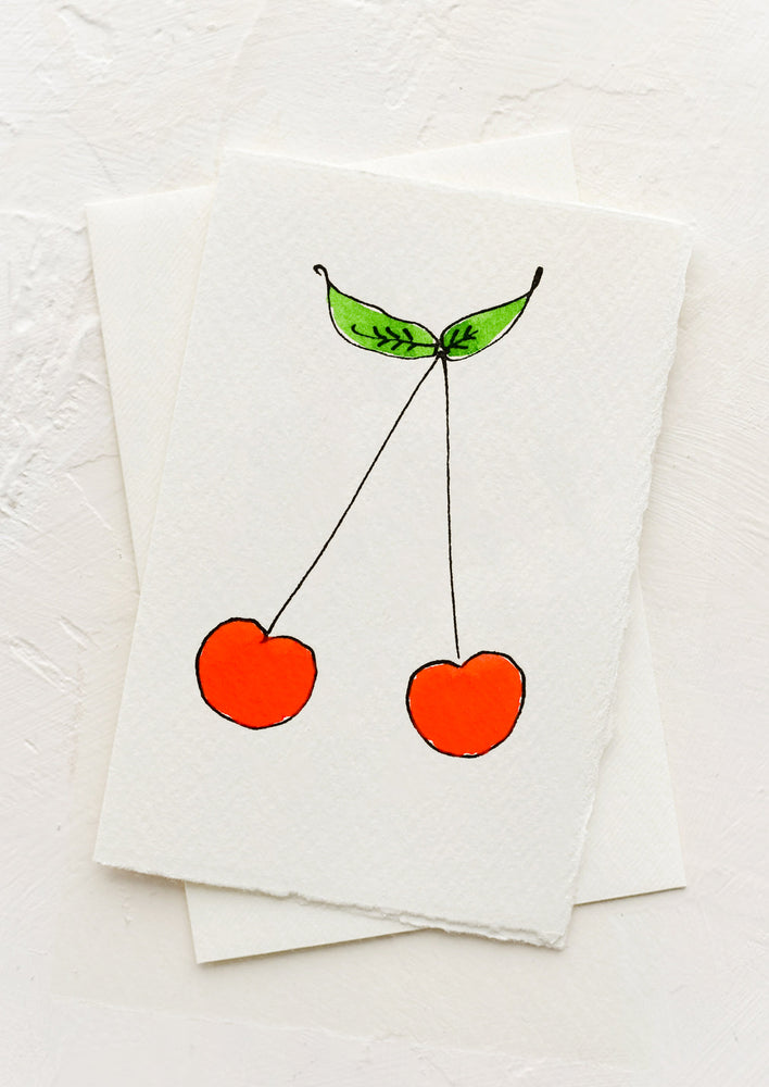 1: A greeting card with illustration of red cherries.