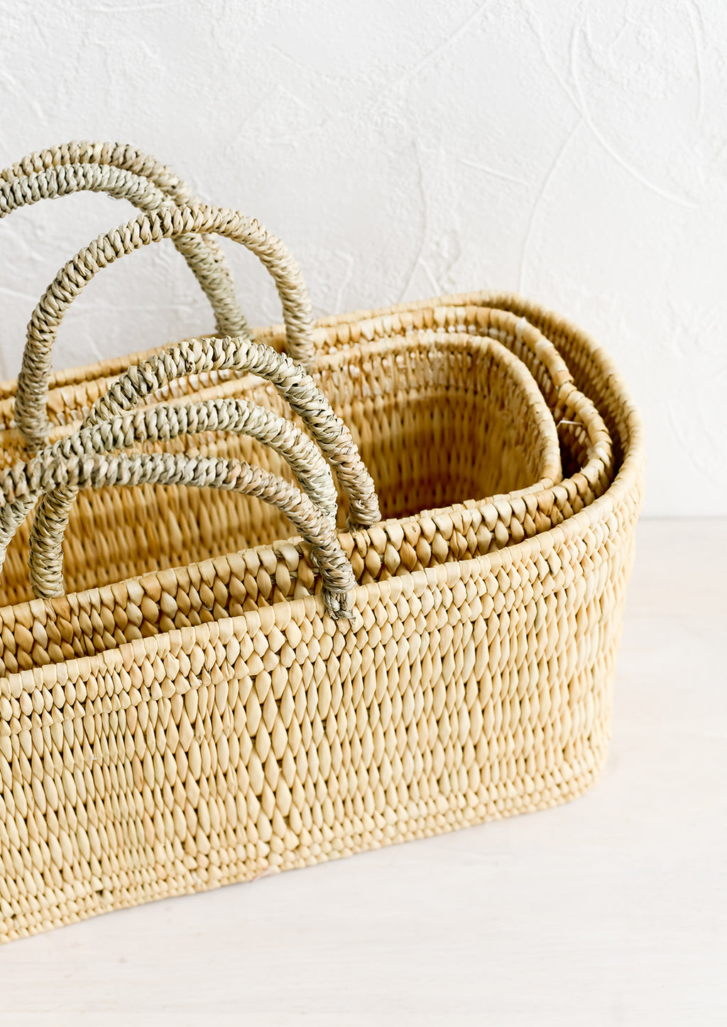 2: Nesting rectangular storage baskets with top handles.