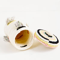 2: Mini woven basket on its side with lid askew to reveal interior canister