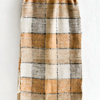1: A table runner in shades of brown, black and white with checker pattern.