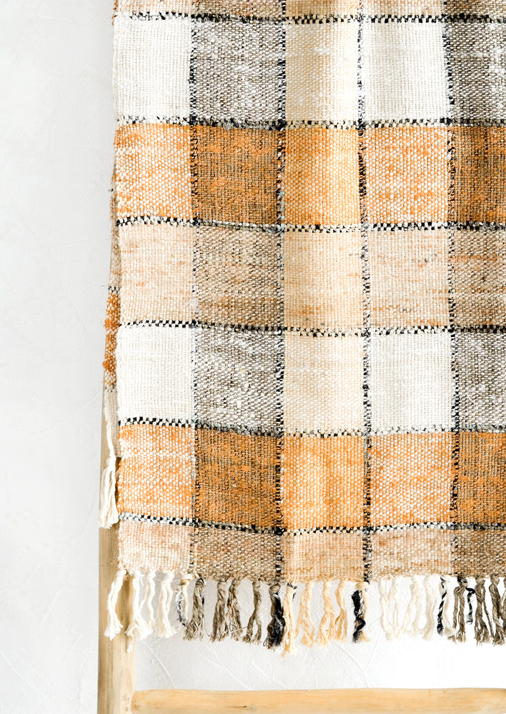 2: A table runner in shades of brown, black and white with checker pattern.