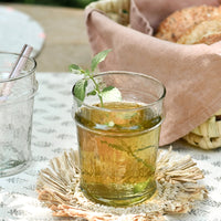 11 oz: A table setting with short glass tumbler holding mint tea.