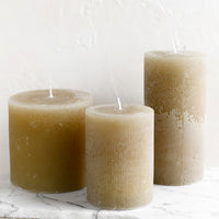 Small / Linen: Three tan colored pillar candles in assorted sizes.
