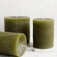 Small / Moss: Three green colored pillar candles in assorted sizes.