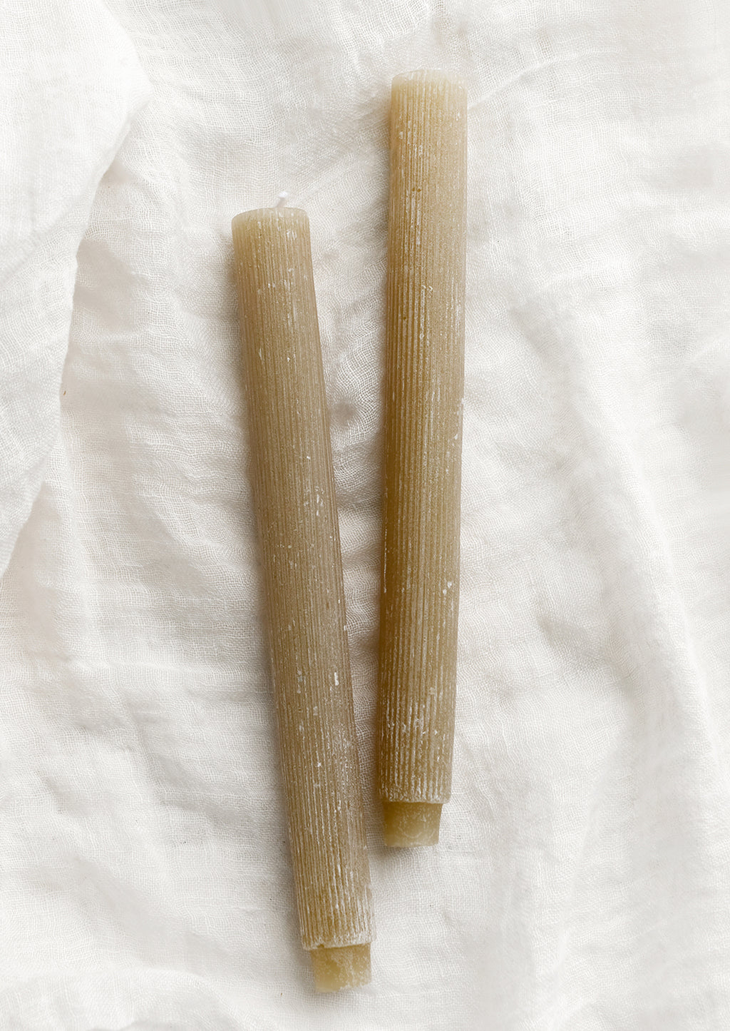 Linen: Taper candles with fine ribbed texture in linen tan.