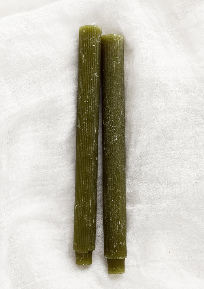 Taper candles with fine ribbed texture in moss green.