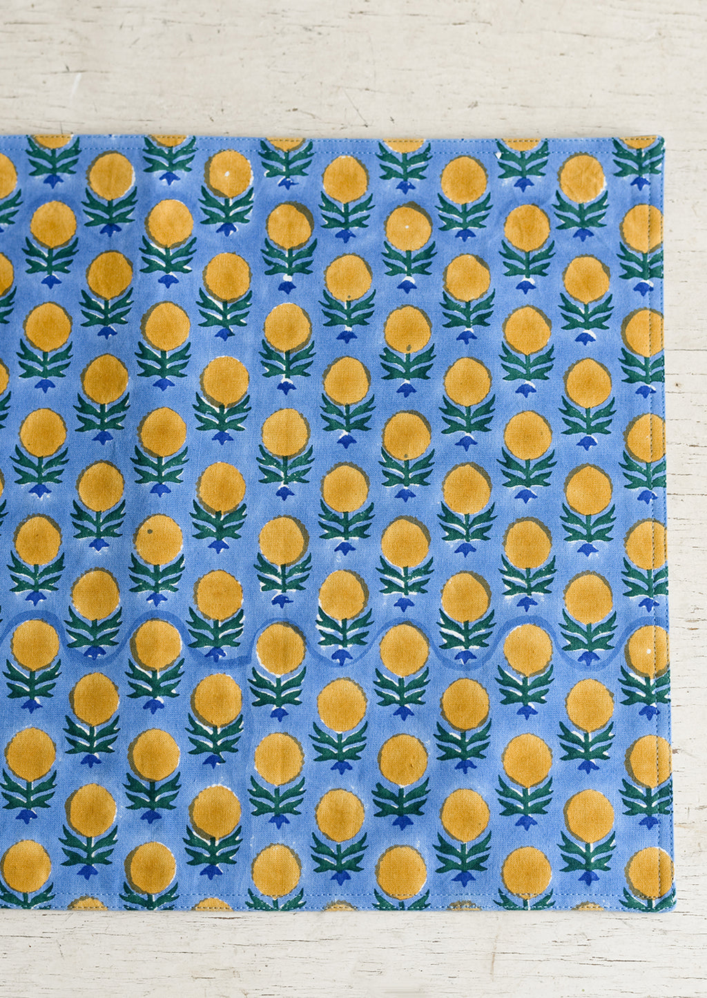 1: A blue and yellow floral block print placemat.