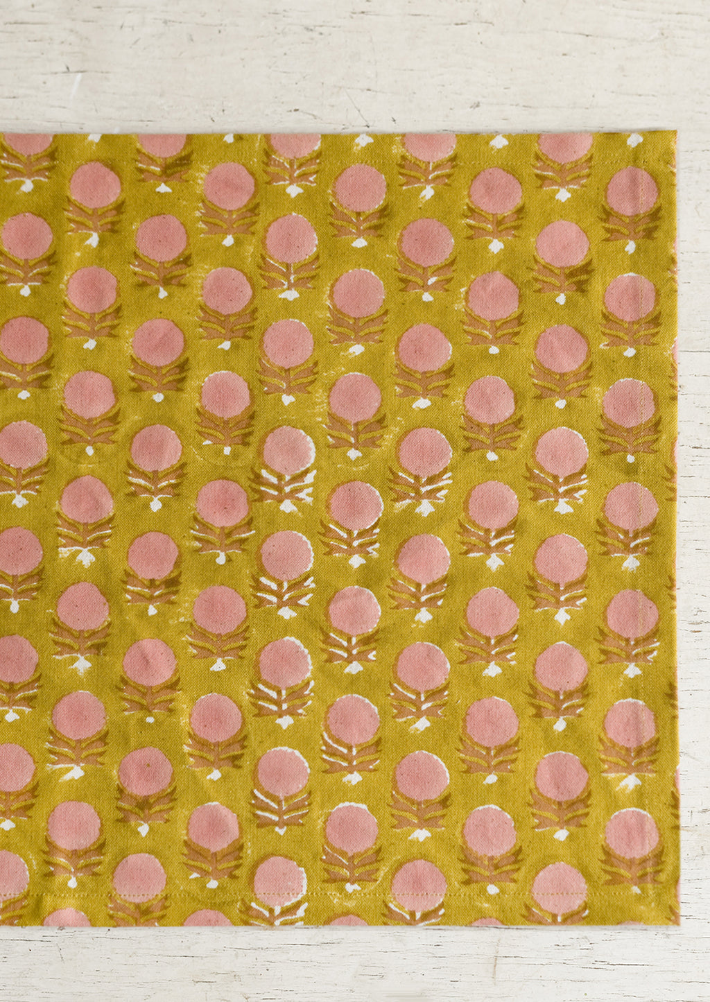 3: A pink and yellow floral block print placemat.
