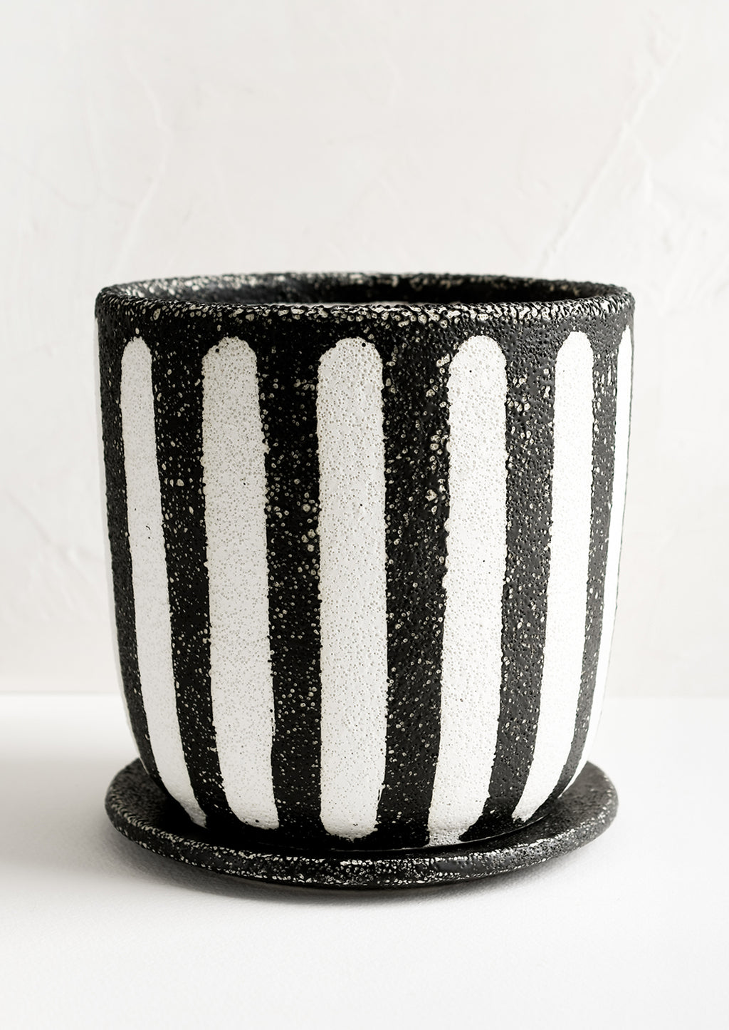 2: A black and white striped planter.