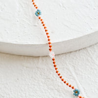 2: A beaded necklace with daisy design.