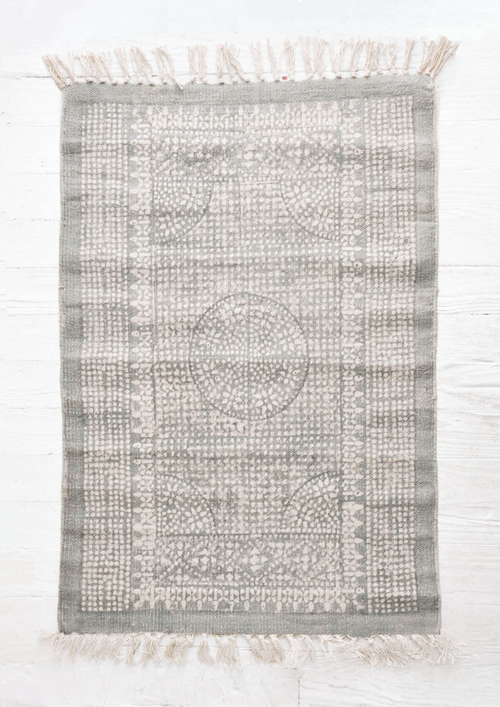 Flatweave rug with contrasting oriental pattern and fringe trimmed edges on two sides