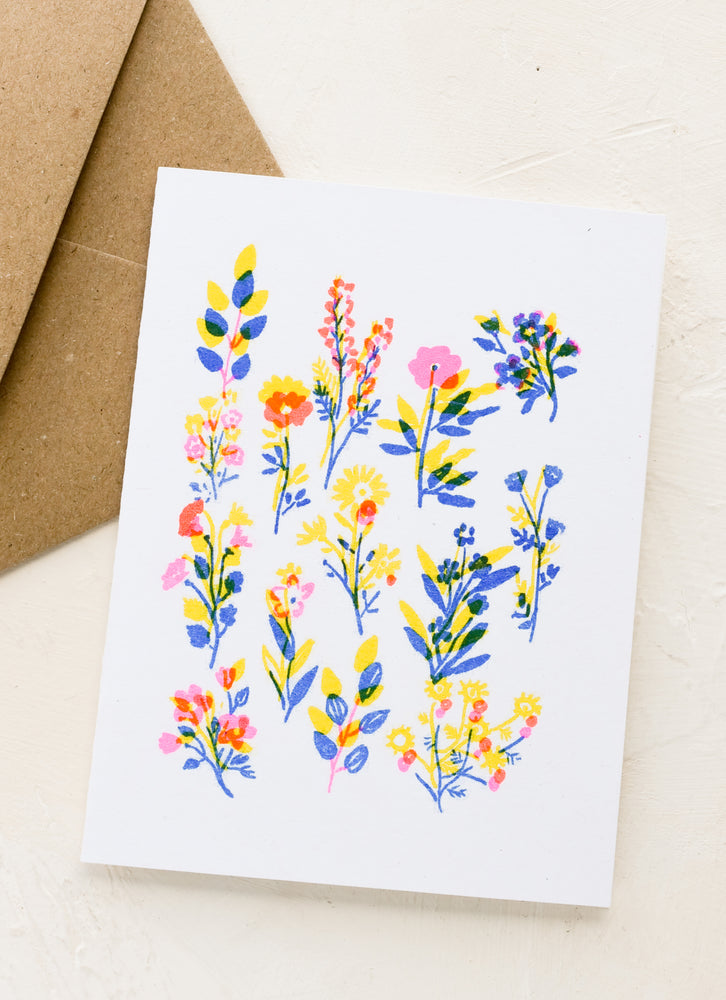 A greeting card with neon floral design.