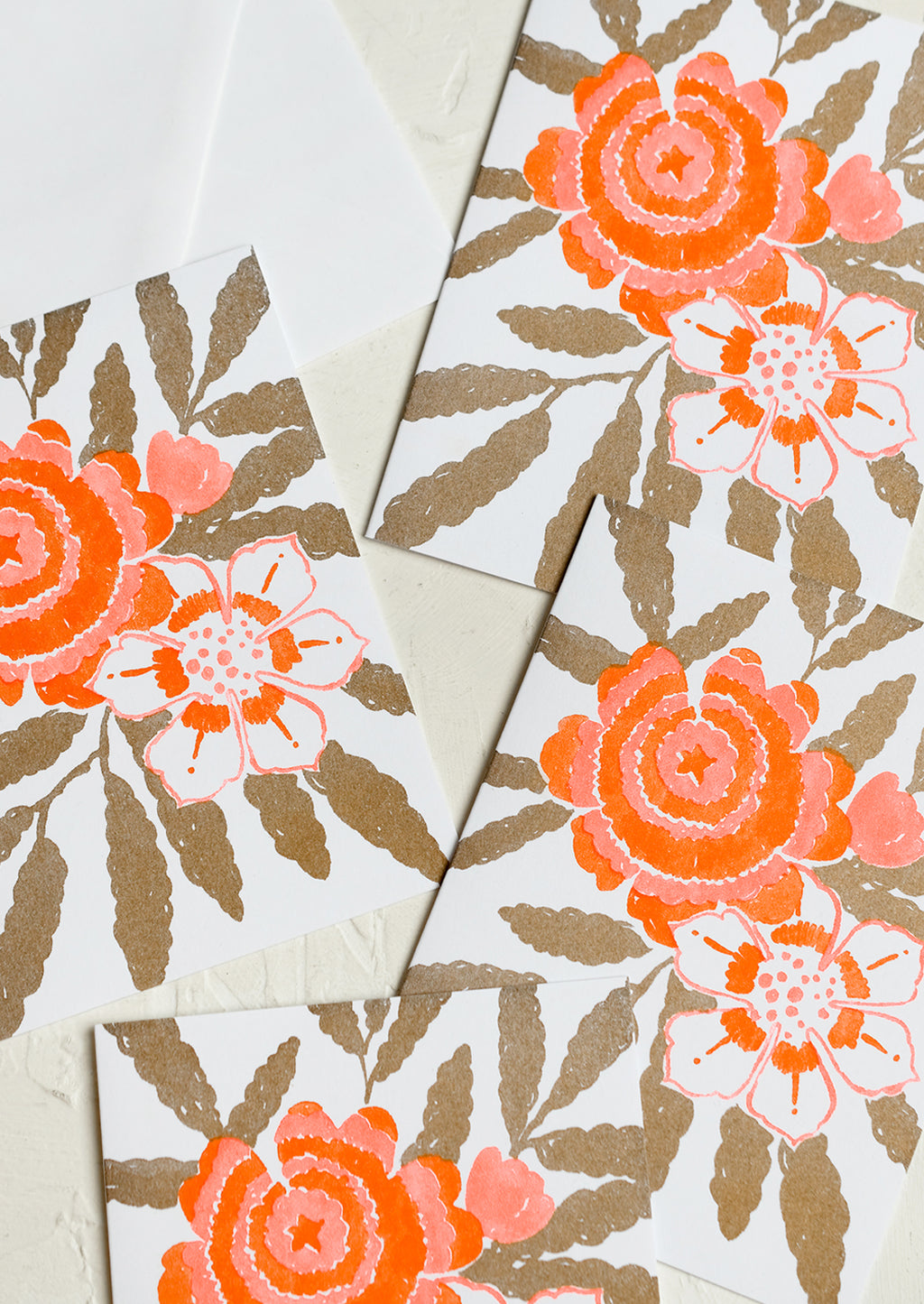 Gold Multi: A floral print card set in gold and neon orange.