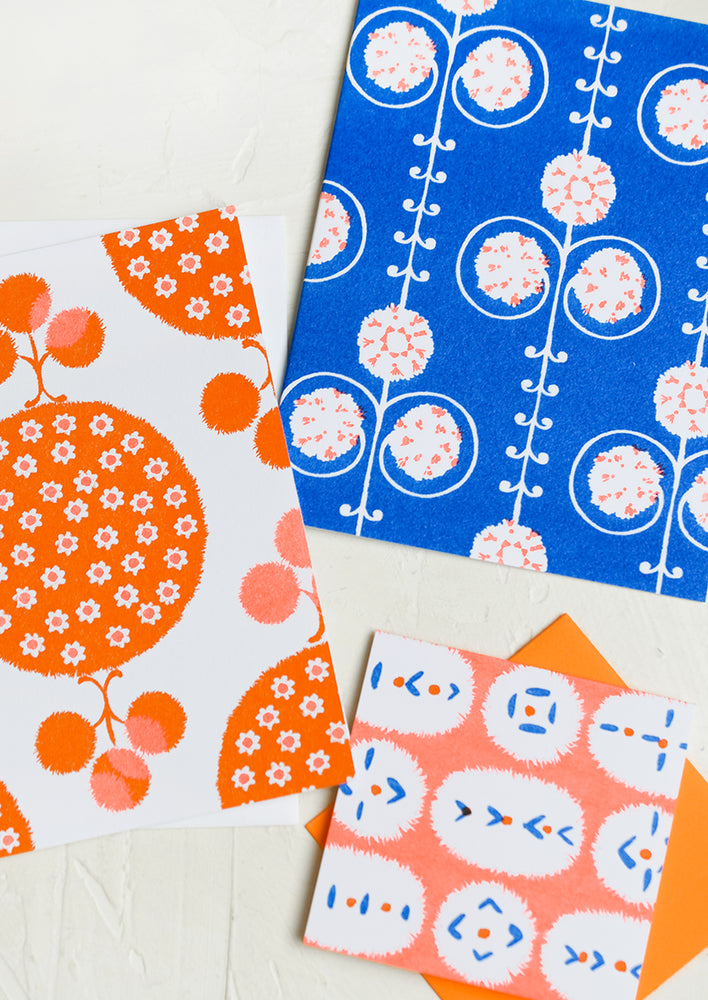 A patterned risograph printed card set in cobalt and orange.
