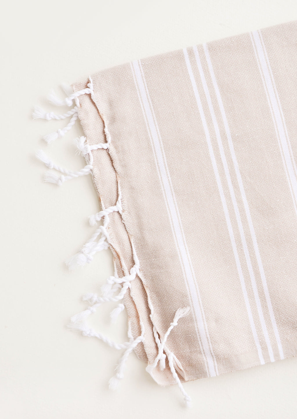 Tan / Hand Towel: Cotton towel with white stripes in tan, twisted fringe on ends
