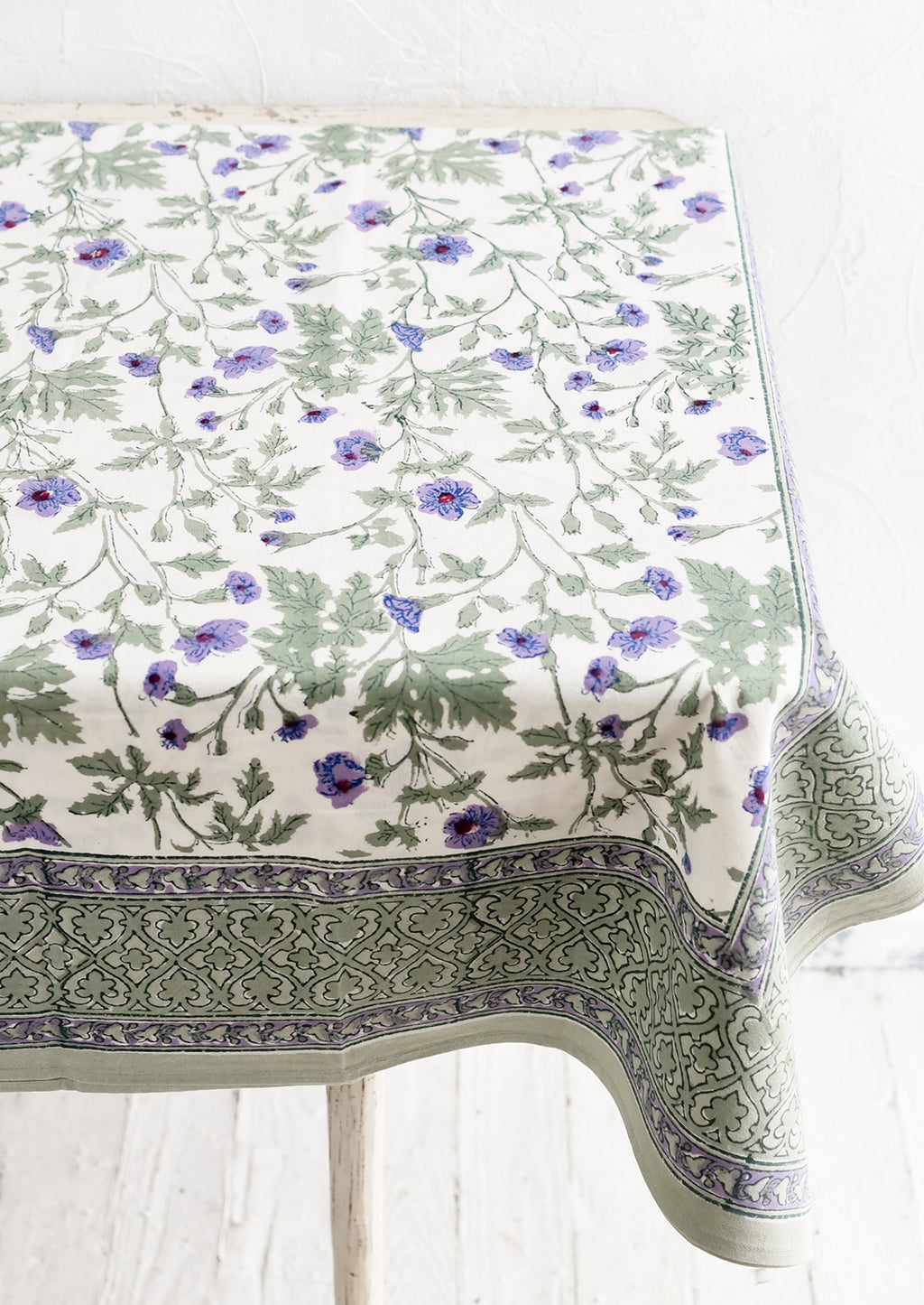 2: A block printed floral tablecloth in purple and green floral.