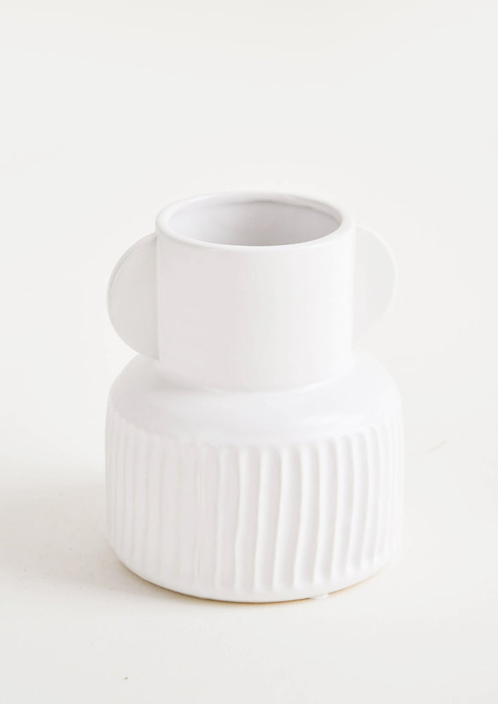 Whimsical, white ceramic vase with ribbed texture around base