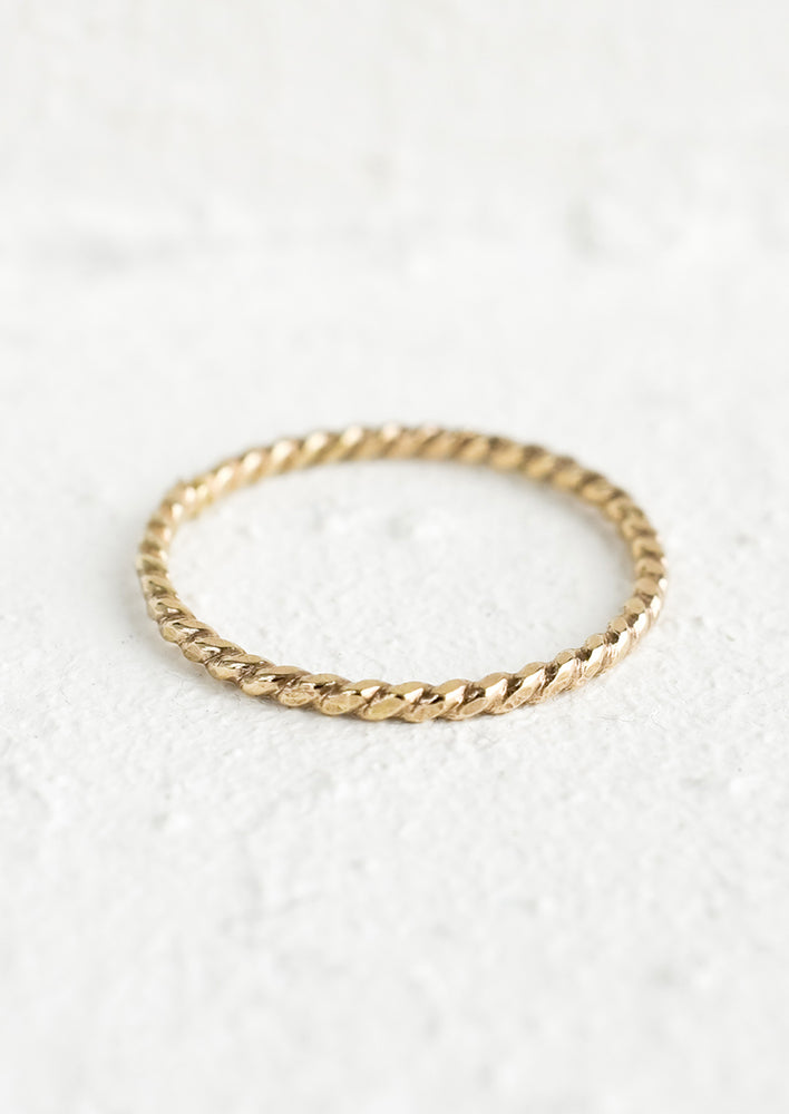 1: A gold stacking ring in braided silhouette.