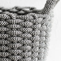 3: A cotton rope basket made with black and white zigzag pattern.