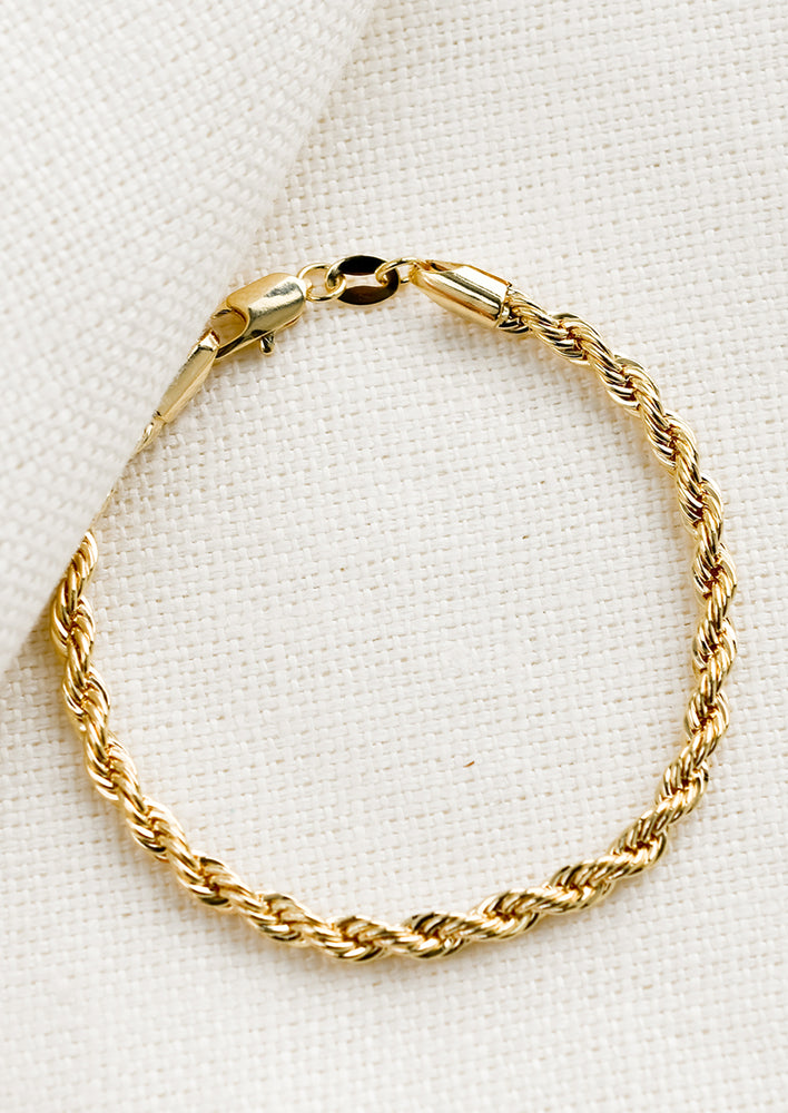 A gold bracelet in rope twist design.