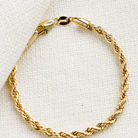 1: A gold bracelet in rope twist design.