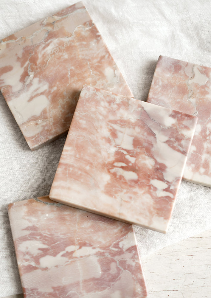 A set of pink and white marble coasters with natural pattern.