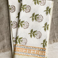 3: A pair of block printed floral napkins in green, mustard and lavender palette.