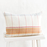 1: Small lumbar throw pillow in natural cotton with contrast embroidery detailing.