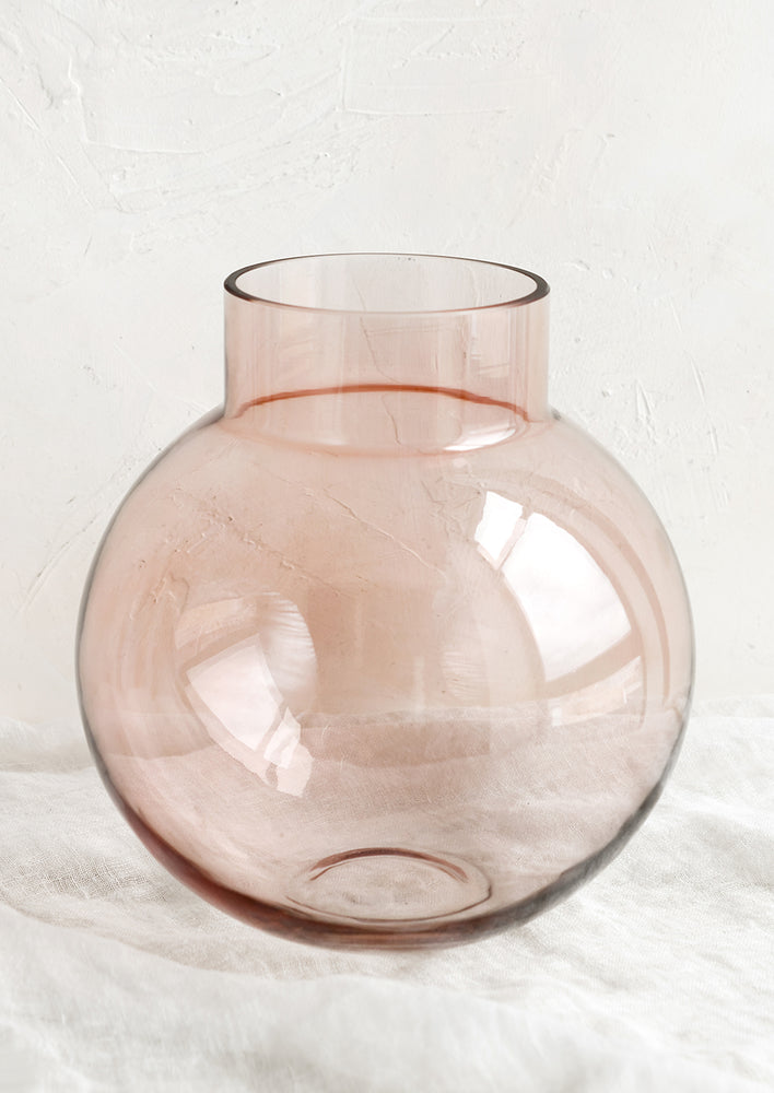 2: A round shaped glass vase in transparent pink.