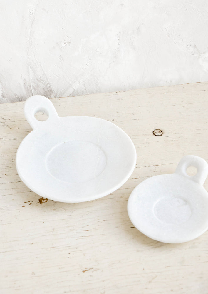 1: Round marble dishes with circular cutout side handle and circular inset at center