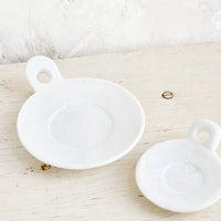 1: Round marble dishes with circular cutout side handle and circular inset at center