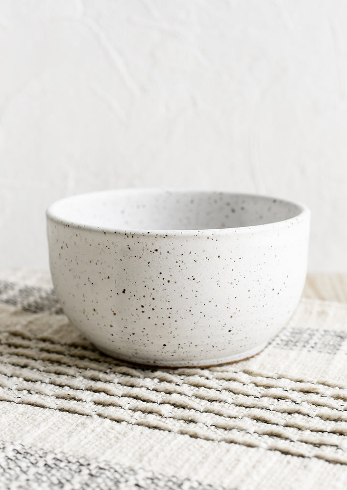 A ceramic cereal bowl in speckled white.