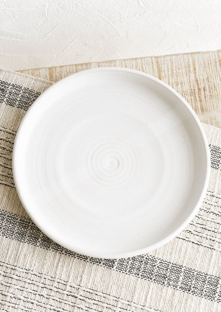 A shallow serving plate in matte white.