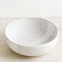 Speckled White: A ceramic serving bowl in matte speckled white.