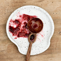 1: A spoon rest with spoon and raspberry jam.