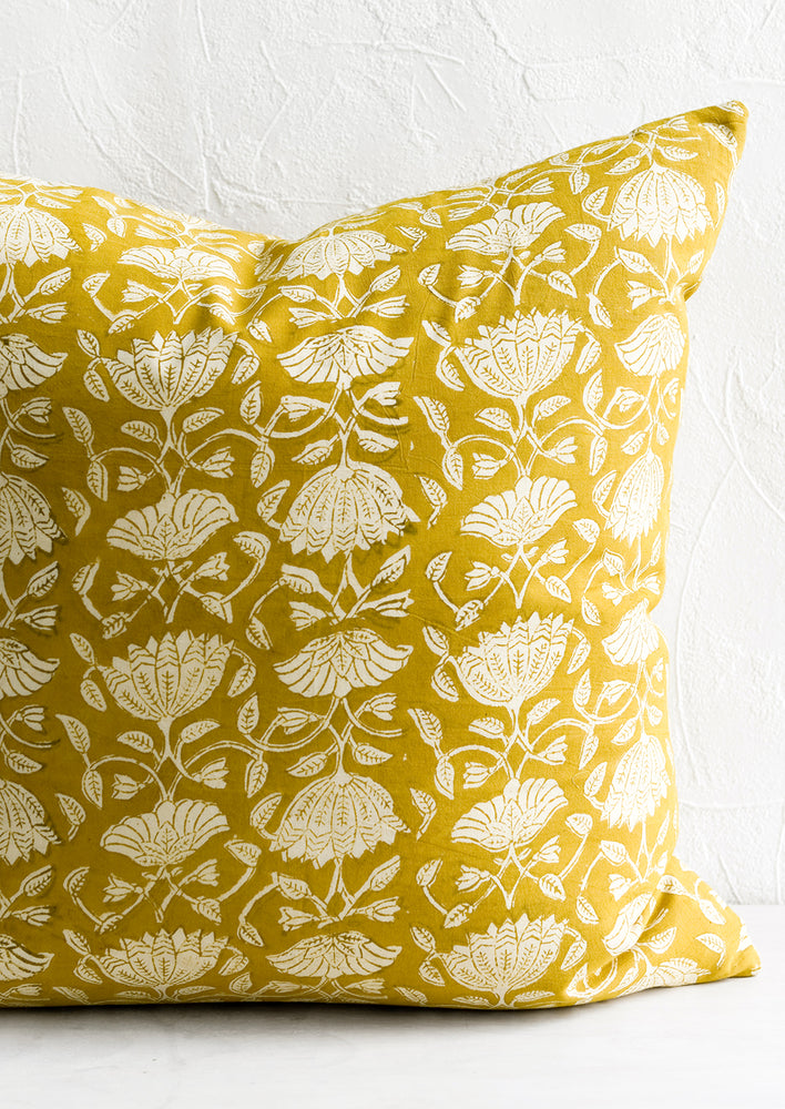 2: A pillow in yellow block print fabric.