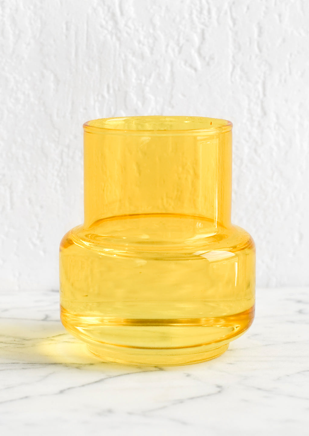 2: A small yellow glass vase.
