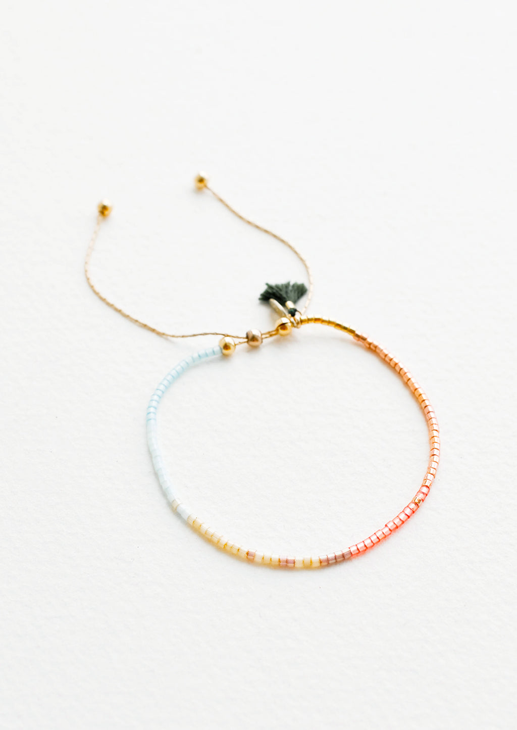 Copper / Sky Blue / Maize: Delicate bracelet of glass beads in a gradient from pale blue to deep rust on a thin gold chain.
