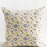1: A block printed pillow in navy, brown and yellow floral print on natural linen.