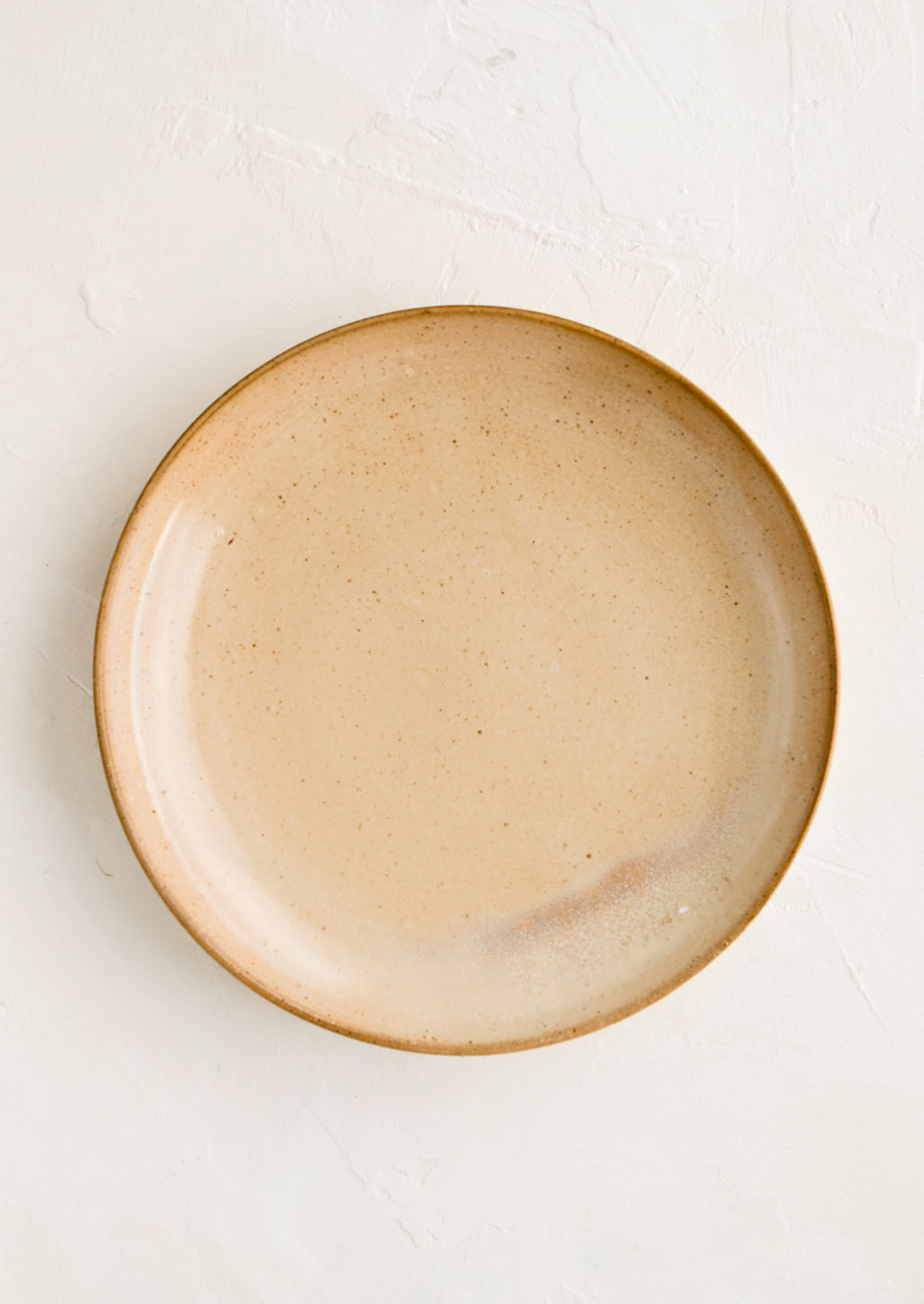 3: A round side plate in a speckled tan glaze.